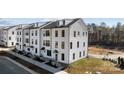 Modern three-story townhouses in a new development, featuring white exteriors at 13005 Moon Rd # 43, Charlotte, NC 28277