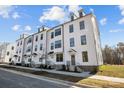 Row of three story townhouses with white siding, and front porches at 13009 Moon Rd # 42, Charlotte, NC 28277