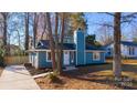 Newly renovated blue house with a landscaped yard and driveway at 2515 Dion Ave, Charlotte, NC 28212