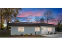 Modern house exterior at dusk showcasing the architectural details and landscaping at 3035 Fallswood Dr, Gastonia, NC 28052
