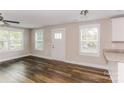 Living room with hardwood floors, white door, and neutral walls at 358 Camden Nw Ct, Concord, NC 28027