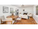 Living room with hardwood floors, fireplace, and adjacent dining area at 916 Pierson Dr, Charlotte, NC 28205