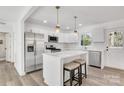 Updated kitchen featuring white cabinets, stainless steel appliances, and an island with bar seating at 941 Newcastle Rd, Gastonia, NC 28052