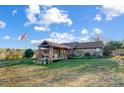 Quaint home with a large covered porch and decorative wagon wheels on the lawn at 13185 Nc 801 Hwy Hwy, Mt Ulla, NC 28125