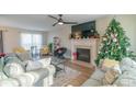 Living room with fireplace, hardwood floors, and Christmas tree at 2800 Churn Ct, Monroe, NC 28110