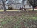 Mobile home with yard and trees in the background at 525 Ridgeland Dr, Cleveland, NC 27013