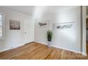 Bright and airy entryway with hardwood floors and tasteful wall art at 6101 Davidson Dr, Matthews, NC 28104