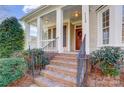 Brick steps leading to a charming front porch with a red door at 7750 Trailridge Dr, Tega Cay, SC 29708