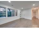 Spacious living area with hardwood floors, white walls, and abundant natural light at 1330 Mulberry Ave, Charlotte, NC 28216