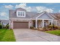 Gray-toned two-story house with stone accents and a brown garage door at 143 Valleymist Ln, Mooresville, NC 28117