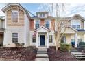 Two-story townhome with a welcoming front porch and landscaped yard at 17608 Caldwell Track Dr, Cornelius, NC 28031