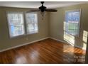 Hardwood floor bedroom with two windows and a ceiling fan at 3806 2Nd Nw Ave, Hickory, NC 28601