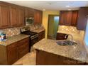 Spacious kitchen featuring granite countertops and dark wood cabinetry at 3806 2Nd Nw Ave, Hickory, NC 28601