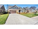 Gray craftsman style home with stone accents and landscaping at 5019 Pleasant Run Dr, Matthews, NC 28104