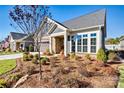 Gray craftsman style home with stone accents and landscaping at 5019 Pleasant Run Dr, Matthews, NC 28104