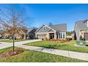 Gray craftsman style home with stone accents and landscaping at 5019 Pleasant Run Dr, Matthews, NC 28104