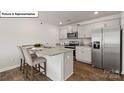 Kitchen island with granite countertops and stainless steel appliances at 5155 Hyrule Dr, Charlotte, NC 28262