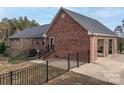 Brick home with attached garage and a black metal fence at 7812 Hwy 742 Hwy, Marshville, NC 28103