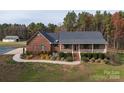 Brick home with front porch, landscaping, and a spacious driveway, offering curb appeal at 7812 Hwy 742 Hwy, Marshville, NC 28103