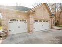 Close-up of a two-story home exterior with a three-car garage at 152 Stacybrook Se Dr, Concord, NC 28025