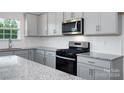 Granite countertops and stainless steel appliances in this modern kitchen at 185 Giant Oak Ave, Statesville, NC 28677