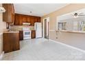 Kitchen featuring wood cabinets, white appliances, and an open view to the dining area at 331 Costner Dr, Bessemer City, NC 28016