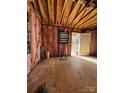 Unfinished room with exposed framing, insulation, and a door leading outside at 915 Mt Gallant Rd, Rock Hill, SC 29730