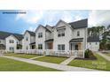 White townhome with black roof, white picket fence, and covered porch at 444 Berryman Rd, Rock Hill, SC 29732