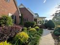Side view of a brick house with a covered porch and a landscaped walkway at 1011 Ratchford Rd # Lot 1&2, York, SC 29745