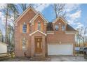 Charming two-story brick home with attached garage and landscaped front yard at 3814 Durham Ln, Charlotte, NC 28269