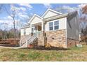 Exterior view of a home with stone and brick accents, and a covered porch at 5120 Kings Pinnacle Dr, Kings Mountain, NC 28086