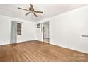 Living room with hardwood floors, ceiling fan, and a partial view of the kitchen at 7811 Casa Loma Rd, Charlotte, NC 28269