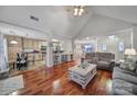 Spacious living area with high ceilings, hardwood floors, and an open floor plan connecting to the kitchen and dining space at 11916 Henderson Hill Rd, Huntersville, NC 28078