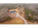 Aerial view of a single-story home with driveway access from a paved road at 13570 Smith Ford Rd, Hickory Grove, SC 29717