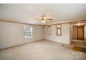 Spacious living room with carpeted floors and ceiling fan at 207 Christy Ln, Locust, NC 28097