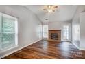 Living room featuring a brick fireplace and wood flooring at 2321 Linda Lou Ct, Charlotte, NC 28213