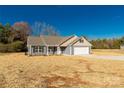 Newly built home with gray siding, beige accents, and a two-car garage at 2450 J B Denton Rd, Lancaster, SC 29720