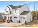 Two-story white home with gray roof, brick accents, and a two-car garage at 10026 Jack Nicklaus Dr # 953, Lancaster, SC 29720