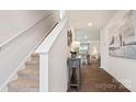 Welcoming foyer with staircase, wood floors, and view to dining area at 12157 Lady Bell Dr, Charlotte, NC 28278