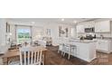 Open-concept kitchen and dining area with white cabinets, granite countertops, and stainless steel appliances at 12157 Lady Bell Dr, Charlotte, NC 28278