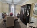 Elegant dining room featuring a large hutch and a chandelier at 12205 Westbury Glen Ct # 17, Charlotte, NC 28262