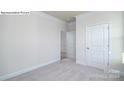 Empty bedroom with neutral-colored walls, carpeting, and a closed door at 2035 Skyhawk Dr, York, SC 29745