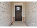 Dark brown front door with a glass panel and stone base at 2491 Seagull Dr, Denver, NC 28037