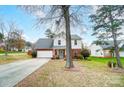 Front view of a two-story house with a driveway, trees, and landscaping at 2916 Waycross Dr, Monroe, NC 28110