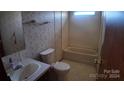 Bathroom with floral wallpaper, bathtub, toilet, and single vanity at 3586 Bridle Path Dr, Vale, NC 28168