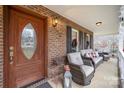 Inviting front porch with wicker furniture and decorative wreaths at 3989 Shakespeare Dr, Hickory, NC 28601