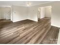 Spacious living area with wood-look flooring, neutral walls, and ample natural light at 10907 Magenta Ln, Charlotte, NC 28262