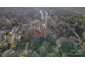 An aerial view showcasing the home's location within a residential neighborhood surrounded by trees at 121 Pam Dr, Gastonia, NC 28056