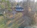 High-angle view of the home and property with surrounding trees and grassy lawn at 121 Pam Dr, Gastonia, NC 28056