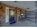 Front porch with seating and entry door at 1350 Kensington Cir, Newton, NC 28658